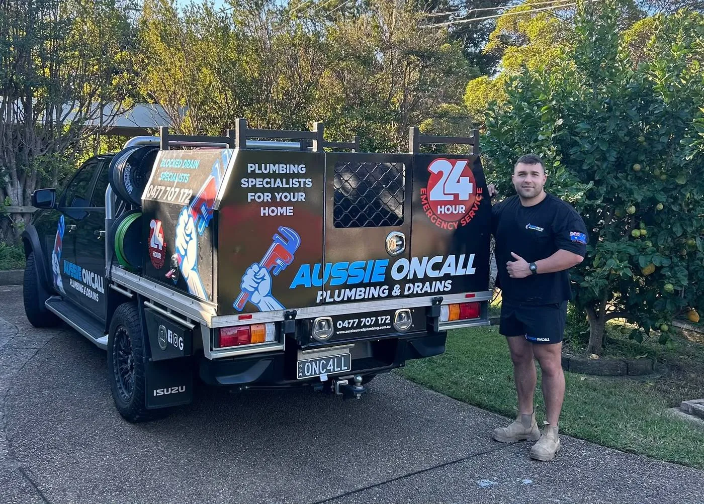 Plumber beside the Aussie Oncall ute, 24-hour service